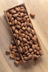 Almonds in old wooden dish