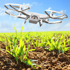 Drone flying over plantation. New tool for farmers use drones to inspect of cultivated fields. Modern technology in farming. Digital artwork of fictional vehicle on agriculture theme. 