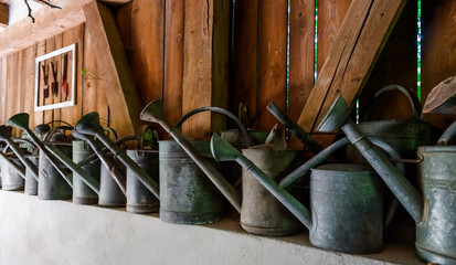 Vintage watering pots using for village house decoration