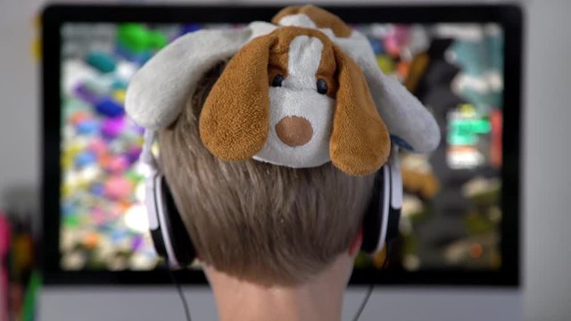 A 7 year old boy playing a computer game.