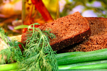 Bread and herbs on a color background