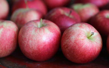 Group of red tasty apples on a red plate