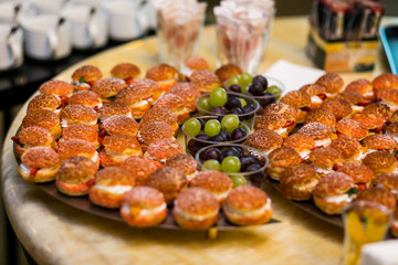 catering banquet table, Canapes on restaurant table, catering, buffet, canapés, stemware, small burgers, grapes