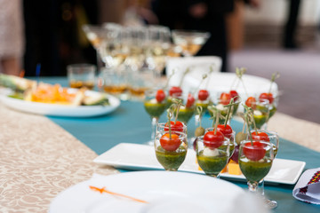 catering banquet table, Canapes on restaurant table, catering, buffet, canapés, stemware, cherry tomatoes and mozzarella