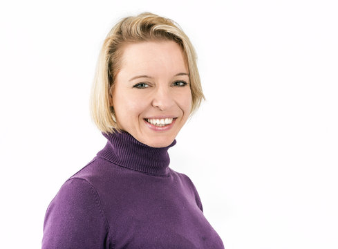Shot of a blonde woman lying and smiling in front of a white background