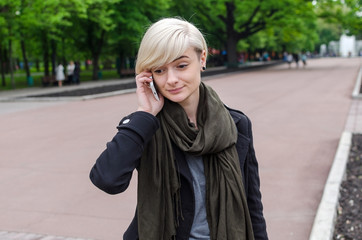 Fototapeta premium Young girl using her phone