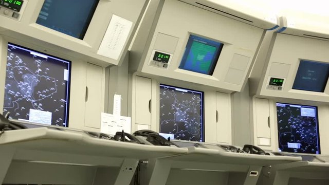 Air traffic controllers at work in the flight control tower at Sofia's airport. Computer monitors. Air traffic control directs aircraft on the ground and through controlled airspace.