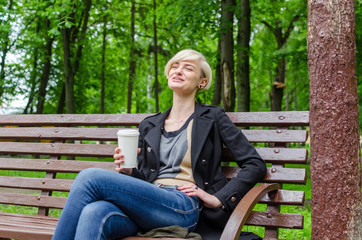 Obraz premium Young girl with a plastic cup of coffee