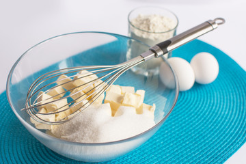 set of products for cooking muffins on the blue napkin