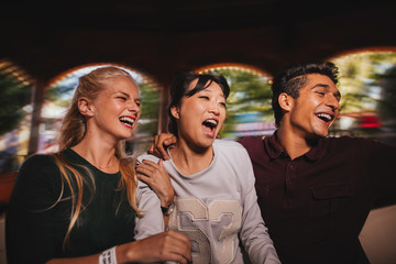 Young man and women having fun together on amusement park