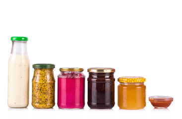 Bottled sauces. Jam and honey jars. On white, isolated background.