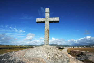 Large stone cross under a blue sky