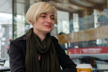 Young girl with a plastic cup of coffee