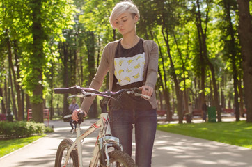 Naklejka premium Young girl with a bicycle