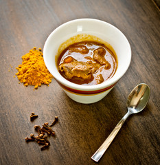 cup of steaming hot soup with spices