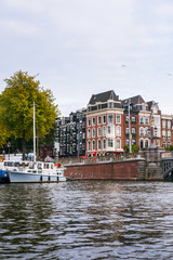 Fototapeta na wymiar Traditional houses of Amsterdam with canals and bridges