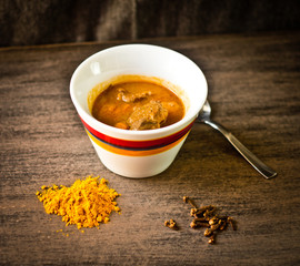 cup of steaming hot soup with spices