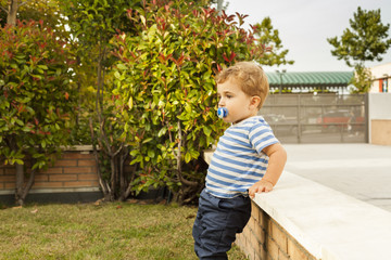 Full shot portrait cute baby boy with pacifier