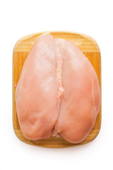 Chicken fillet on the board. On white, isolated background.Top view. Flat lay.
