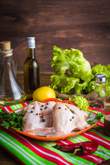 Cooking chicken wings. The table with the ingredients for the dishes. On a wooden background.
