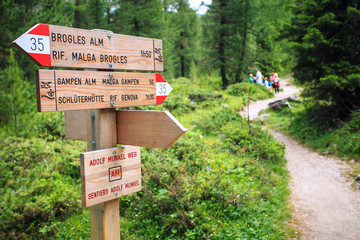 Wooden pointer for hikers on the Adolf Munkel trail in the Dolomites