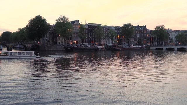 typical floating bridge by night in Amsterdam the Netherlands