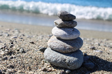 Fototapeta na wymiar Balance Zen Stones on Sand Sea