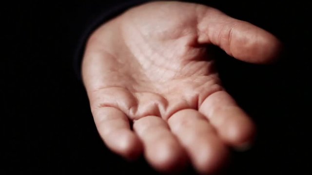 Adult woman spill on hand pills. Addiction concept. Female pours bunch of pills into the palm of her hand in a dark room