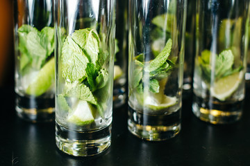 Mint ice and lime in the glasses. Close-up.