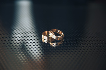 wedding Rings on a perforated metal
