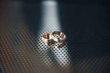 wedding Rings on a perforated metal