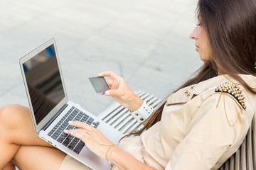 Young woman using credit card