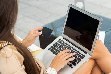 woman using credit card in the cafe