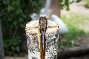 ax, hatchet, axe. split a log with an ax. the brow in the backgr