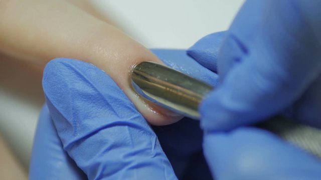 Manicurist handles cuticles with special nozzles