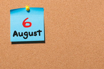 August 6th. Day 6 of month, color sticker calendar on notice board. Summer time. Empty space for text
