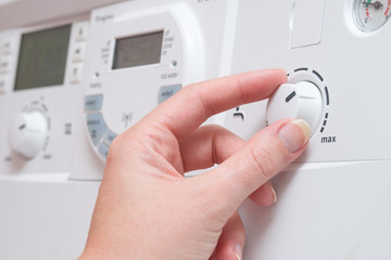 Hand Adjusting Hot Water Dial on Boiler