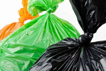 Black, green and orange garbage bags