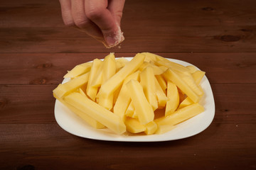 slicing raw potato on the plate