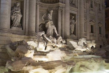View of Fontana Di Trevi at night in Rome. Aqueduct-fed rococo fountain, designed by Nicola Salvi & completed in 1762, with sculpted figures.