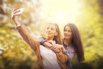 Friends making selfie. Two beautiful young women making selfie.