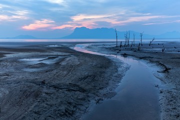 Sunset on a muddy beach