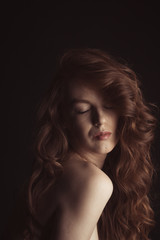 Sensual woman with long hair and closed eyes