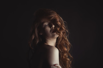 Naklejka premium Gorgeous woman with shadow on her face and wavy hair