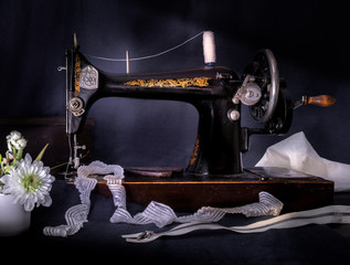 Classic retro style manual sewing machine ready for  work, scissors, fabric and Chrysanthemum
