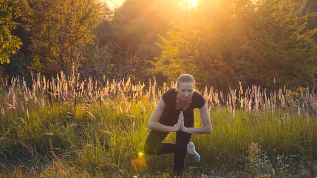 Girl on the nature of the exercise. Beautiful deflection element workout yoga element.