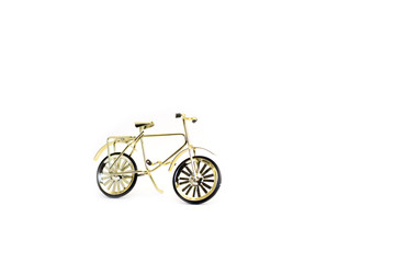 Toy gold bicycle. Isolated on white background