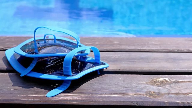 Swimming equipment on the edge of a swimming pool, dolly