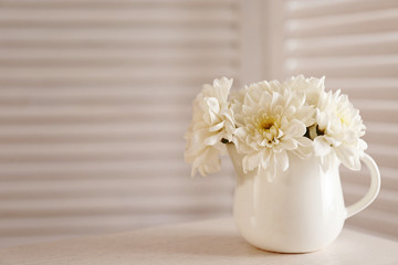 Bouquet of beautiful flowers in a pot on a  table