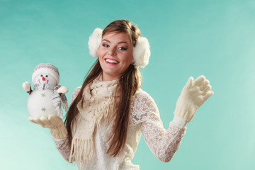 Smiling cute woman with little snowman. Winter.